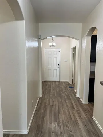 a view of a room with wooden floor