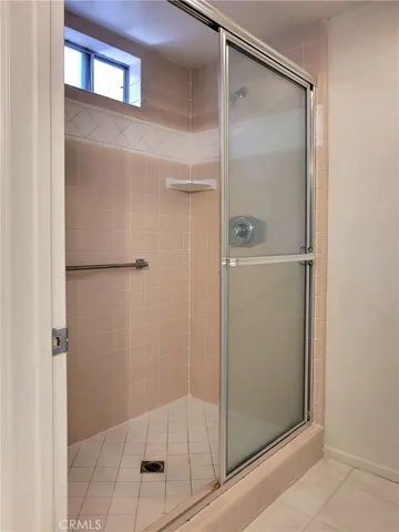 a bathroom with a glass shower door