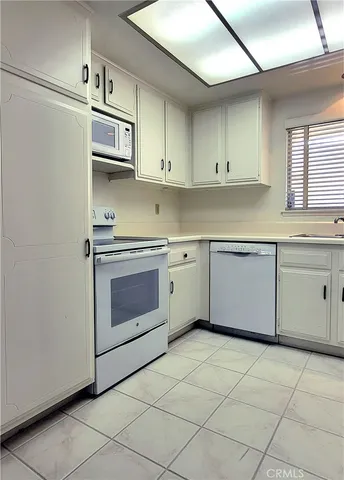 a kitchen with a stove sink and cabinets