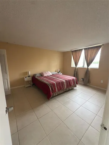 a bathroom with a granite countertop toilet and a shower