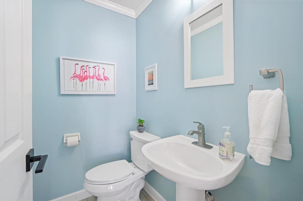 135 Bath Club Circle North Redington Beach, FL 33708 - Photo 15 of 45 a bathroom with a toilet sink and mirror