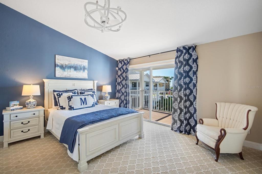 135 Bath Club Circle North Redington Beach, FL 33708 - Photo 17 of 45 a bedroom with a bed and a chair