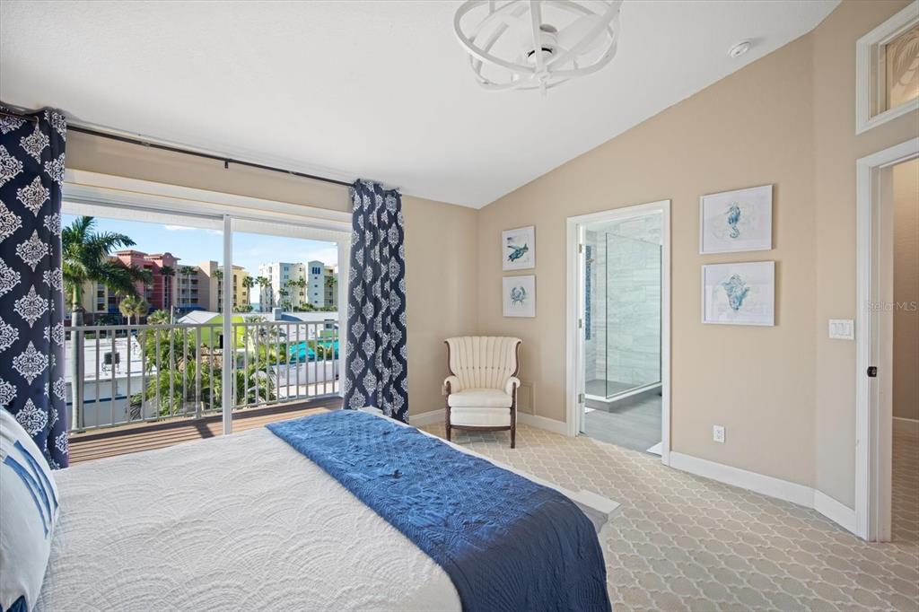 135 Bath Club Circle North Redington Beach, FL 33708 - Photo 18 of 45 a bedroom with a large bed and a window