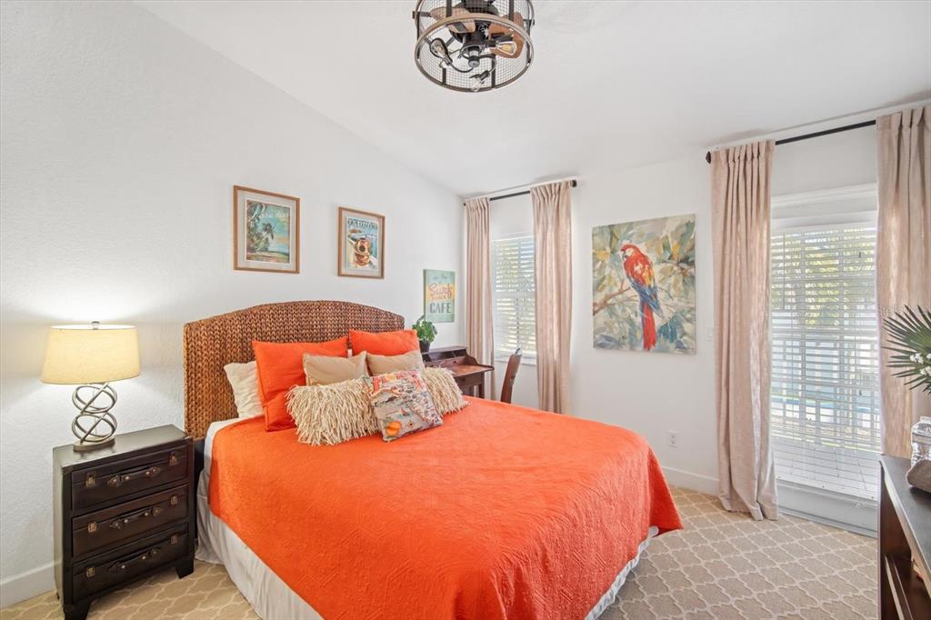 135 Bath Club Circle North Redington Beach, FL 33708 - Photo 24 of 45 a bedroom with a bed and a lamp on a dresser