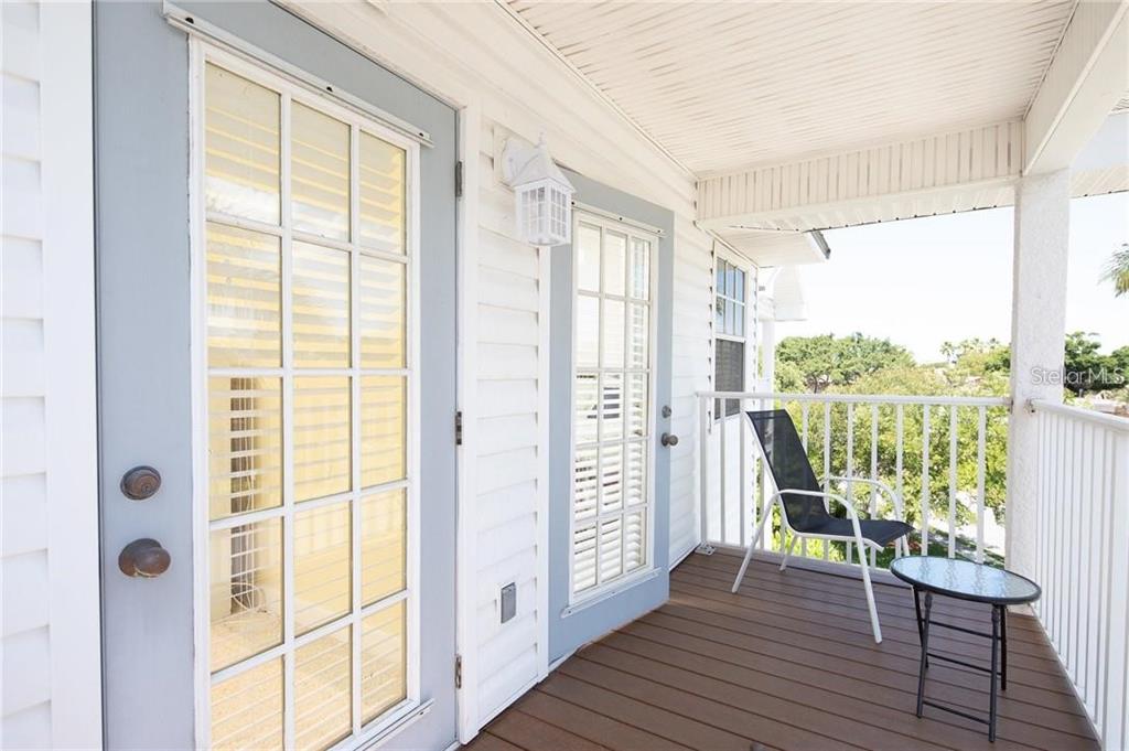 135 Bath Club Circle North Redington Beach, FL 33708 - Photo 26 of 45 a view of front door deck house with wooden floor