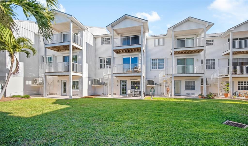 135 Bath Club Circle North Redington Beach, FL 33708 - Photo 30 of 45 a large building with a yard in front of it