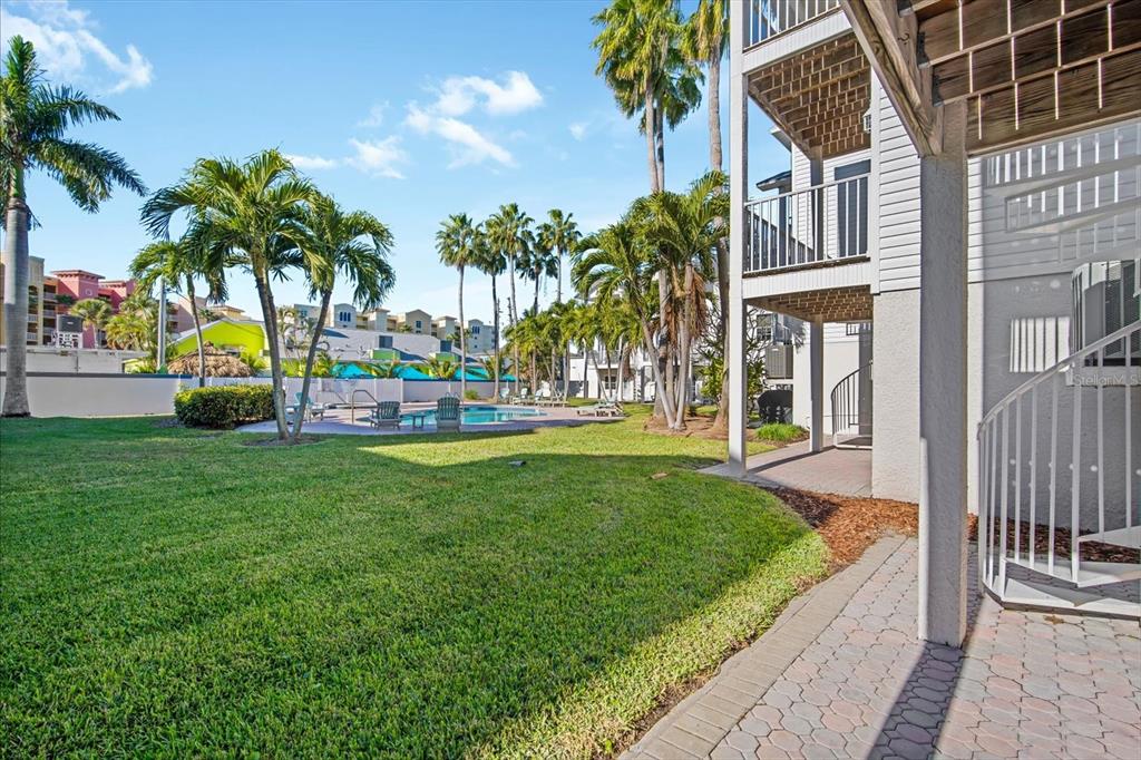 135 Bath Club Circle North Redington Beach, FL 33708 - Photo 31 of 45 a view of a house with garden and a patio