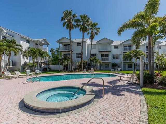 135 Bath Club Circle North Redington Beach, FL 33708 - Photo 32 of 45 a view of a swimming pool with a patio