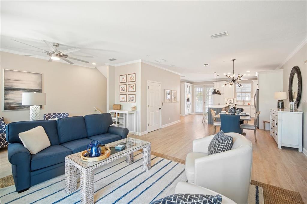 135 Bath Club Circle North Redington Beach, FL 33708 - Photo 6 of 45 a living room with furniture and a chandelier