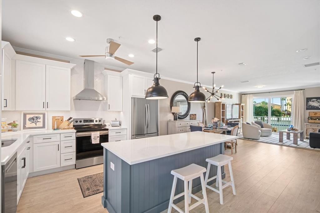 135 Bath Club Circle North Redington Beach, FL 33708 - Photo 10 of 45 a kitchen with a stove a table and chairs
