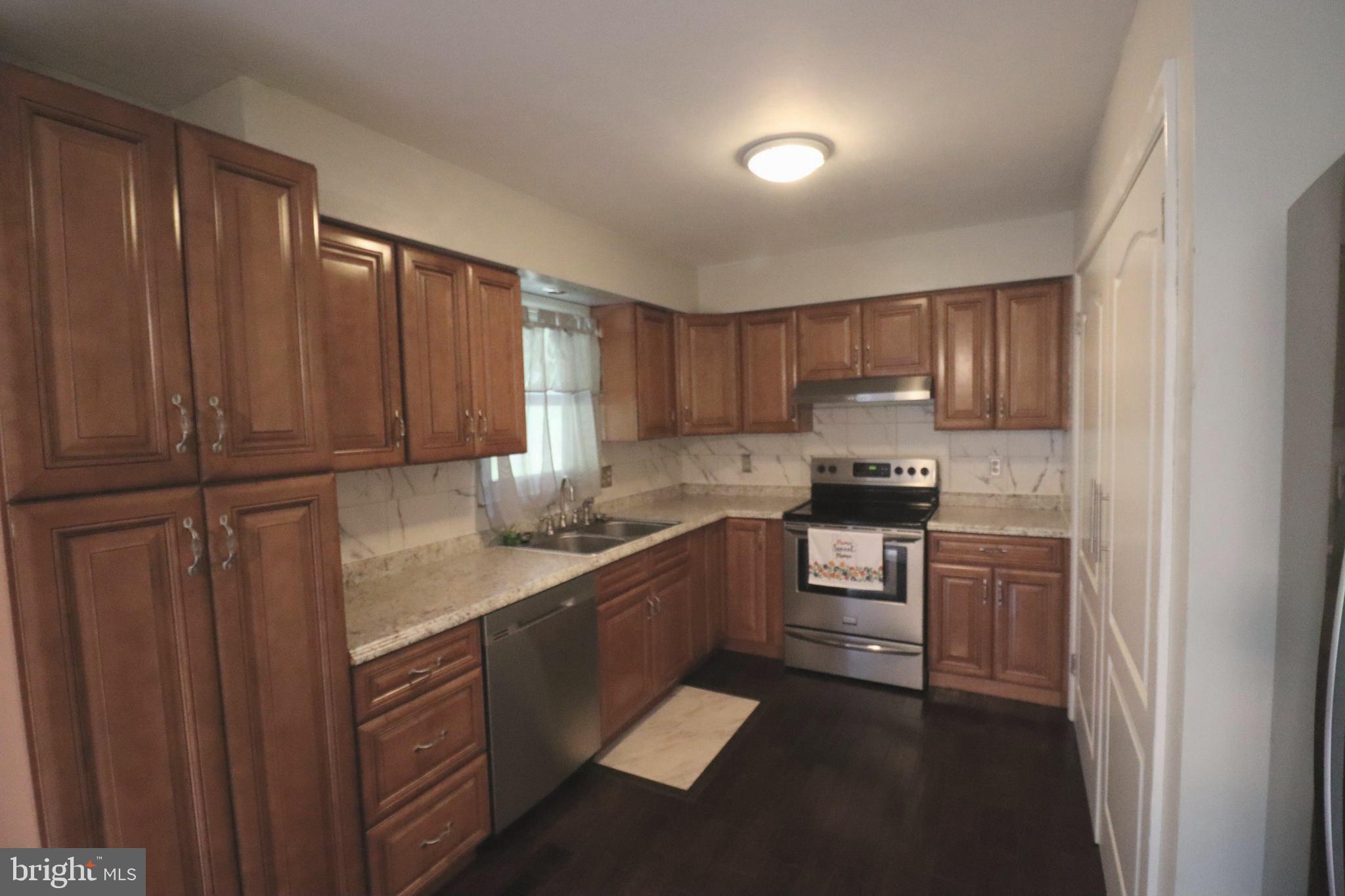49 Valley View Drive Hanover, PA 17331 - Photo 20 of 64 a kitchen with granite countertop wooden cabinets and stainless steel appliances