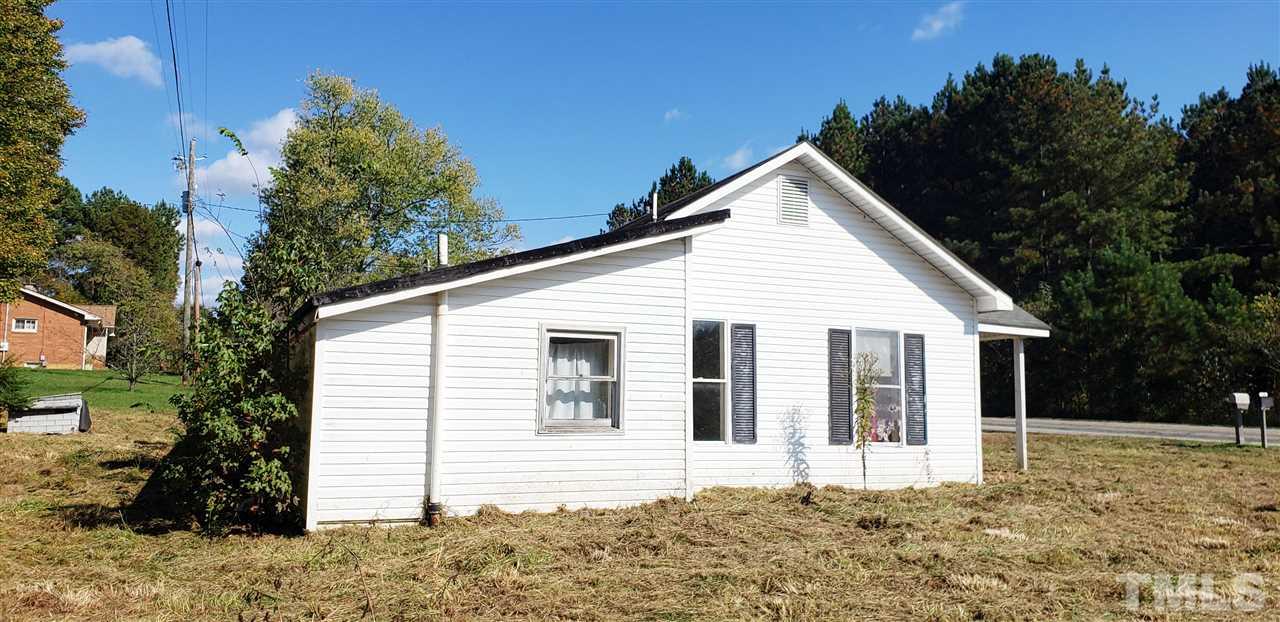 1195 Concord Ceffo Road Roxboro, NC 27574 - Photo 6 of 7 a view of a white house next to yard