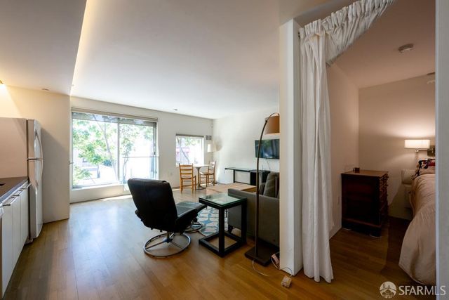 a view of a livingroom with workspace and a window