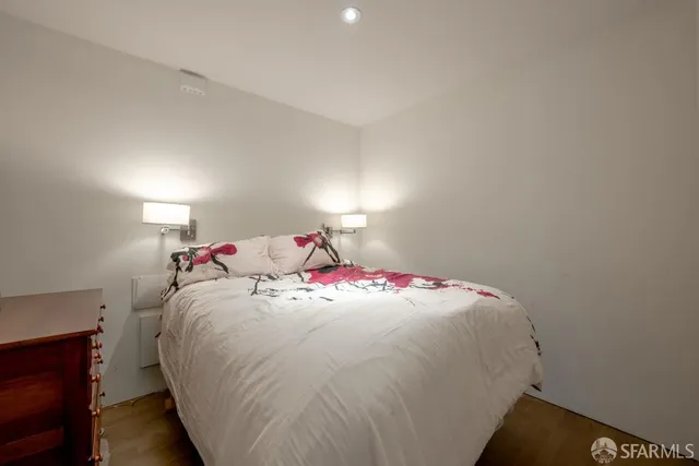 a bedroom with a bed and a dresser