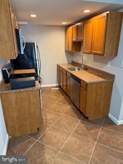 41 Fleming Street Newark, DE 19713 - Photo 5 of 13 a kitchen with stainless steel appliances a sink a stove a microwave a counter top space and cabinets
