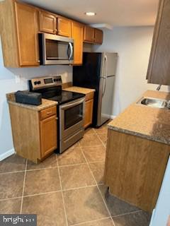 41 Fleming Street Newark, DE 19713 - Photo 6 of 13 a kitchen with stainless steel appliances a stove a microwave and a sink
