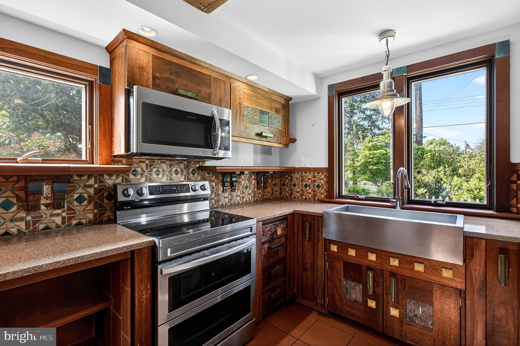 498 Perrineville Road Robbinsville, NJ 08691 - Photo 9 of 59 a kitchen with a stove a sink and a microwave