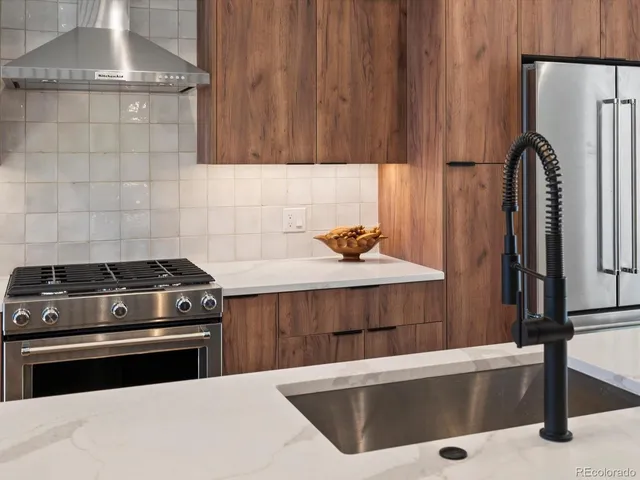 a kitchen with a stove and a refrigerator