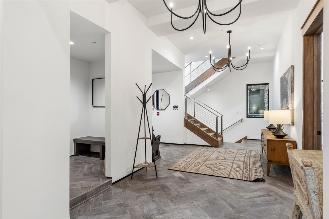 1855 Burgess Creek Road, Unit 4 Steamboat Springs, CO 80487 - Photo 12 of 45 a living room with lots of white furniture and a chandelier