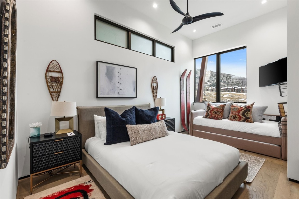 1855 Burgess Creek Road, Unit 4 Steamboat Springs, CO 80487 - Photo 14 of 45 a bedroom with furniture and a flat screen tv