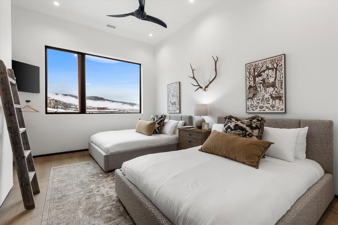 1855 Burgess Creek Road, Unit 4 Steamboat Springs, CO 80487 - Photo 15 of 45 a bedroom with two beds and a large mirror