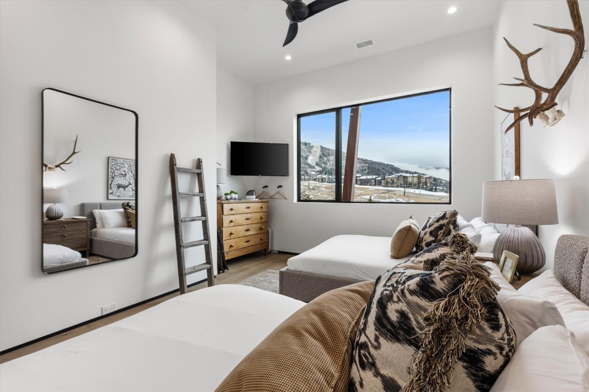 1855 Burgess Creek Road, Unit 4 Steamboat Springs, CO 80487 - Photo 16 of 45 a bedroom with furniture and a flat screen tv