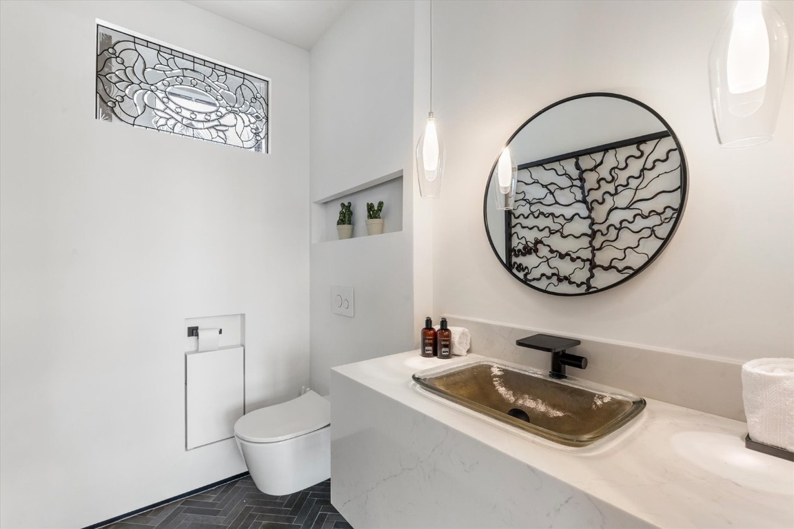 1855 Burgess Creek Road, Unit 4 Steamboat Springs, CO 80487 - Photo 24 of 45 a bathroom with a toilet a sink and a mirror