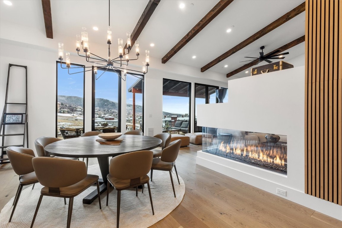 1855 Burgess Creek Road, Unit 4 Steamboat Springs, CO 80487 - Photo 25 of 45 a dining room with furniture a chandelier and window