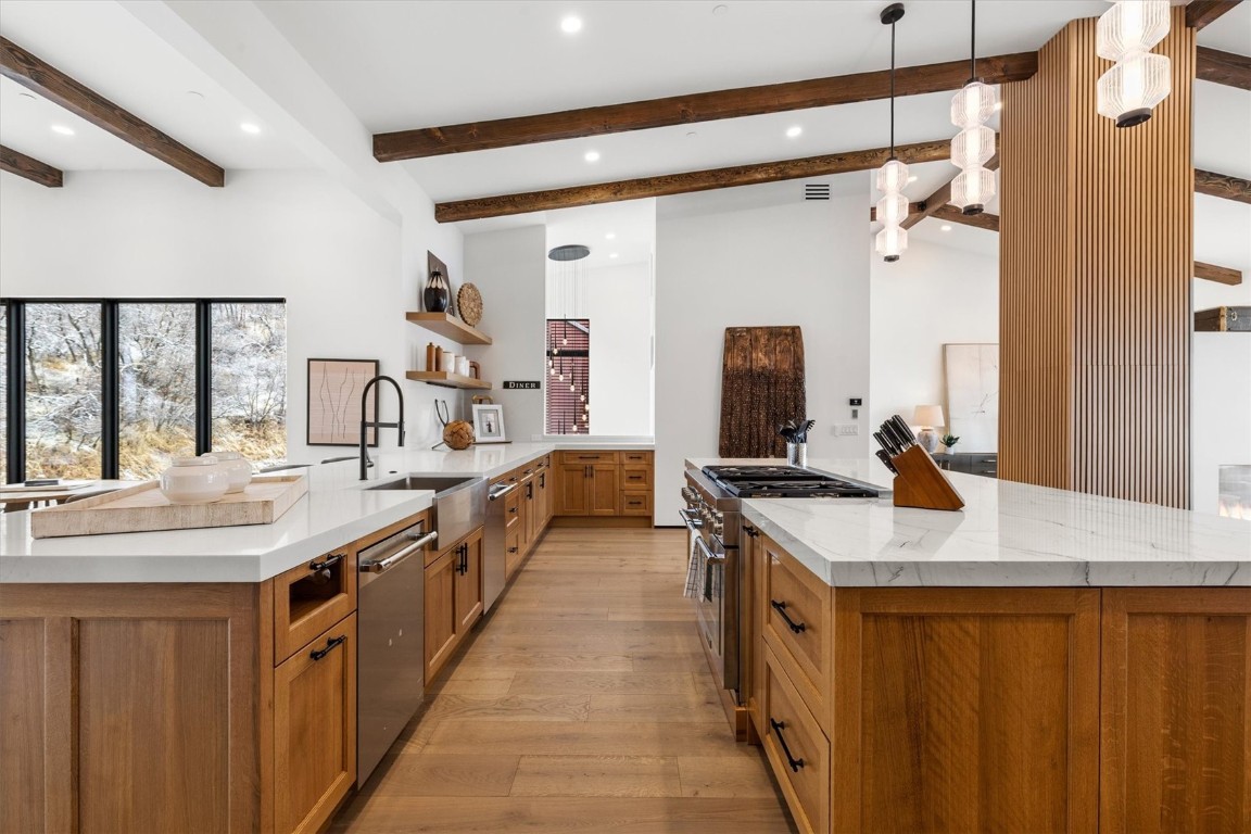 1855 Burgess Creek Road, Unit 4 Steamboat Springs, CO 80487 - Photo 30 of 45 a large kitchen with a sink and a wooden floor