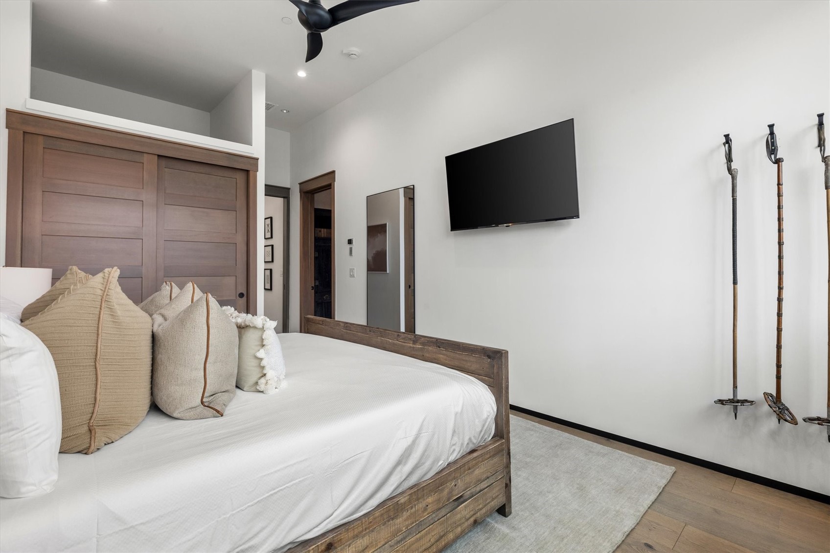 1855 Burgess Creek Road, Unit 4 Steamboat Springs, CO 80487 - Photo 35 of 42 a bedroom with a bed flat screen tv and a couch