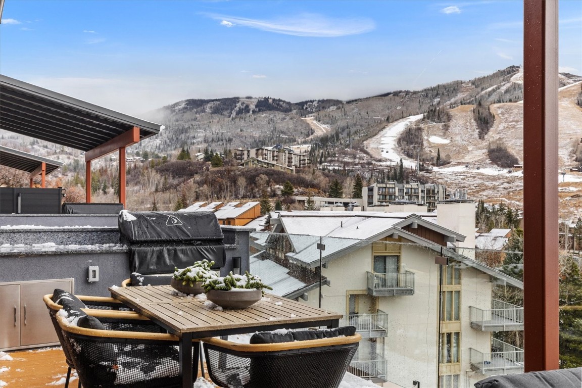 1855 Burgess Creek Road, Unit 4 Steamboat Springs, CO 80487 - Photo 38 of 45 a view of a terrace with furniture and a table