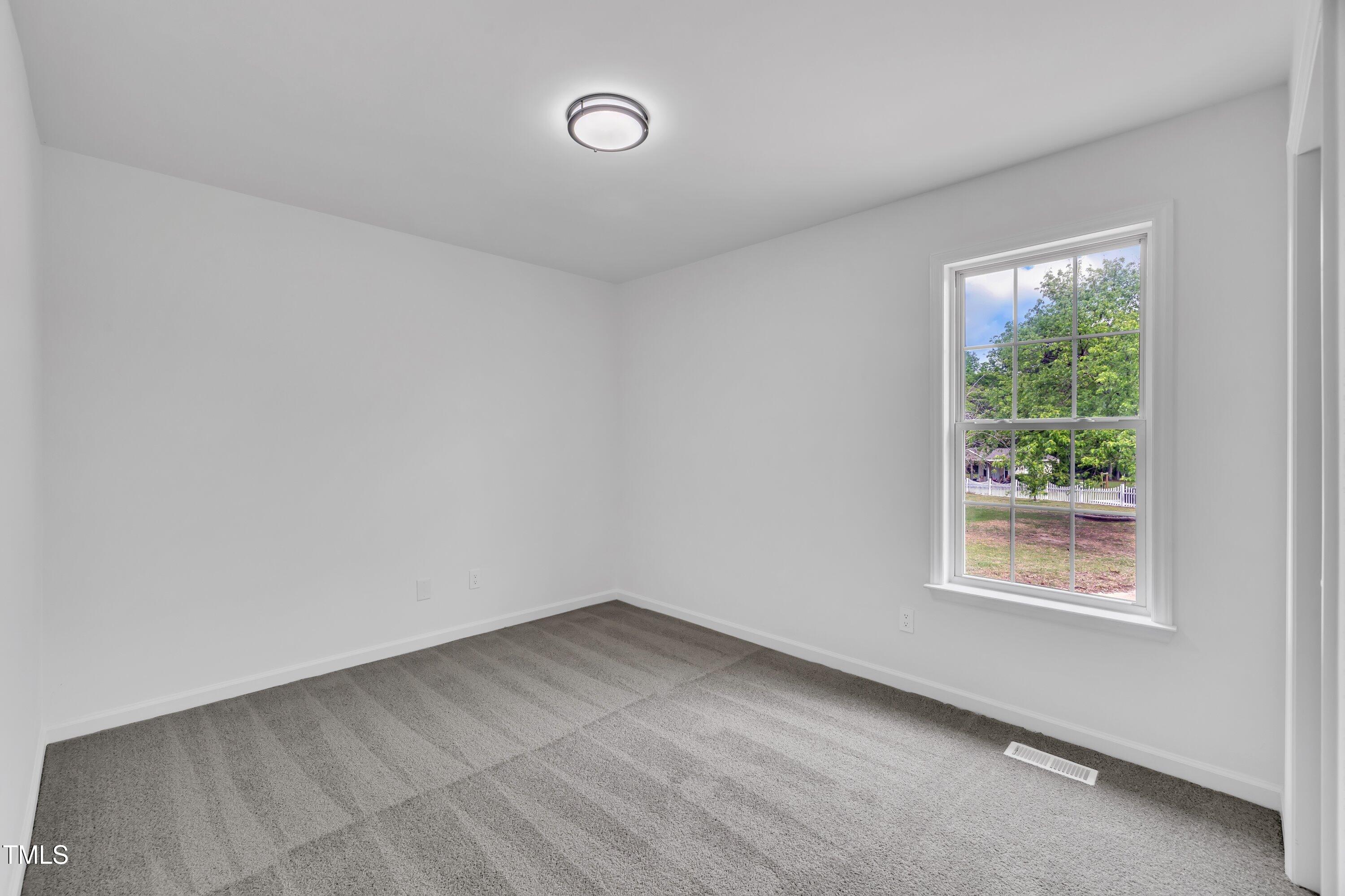 112 Edmondson Drive Willow Spring, NC 27592 - Photo 17 of 32 an empty room with a window
