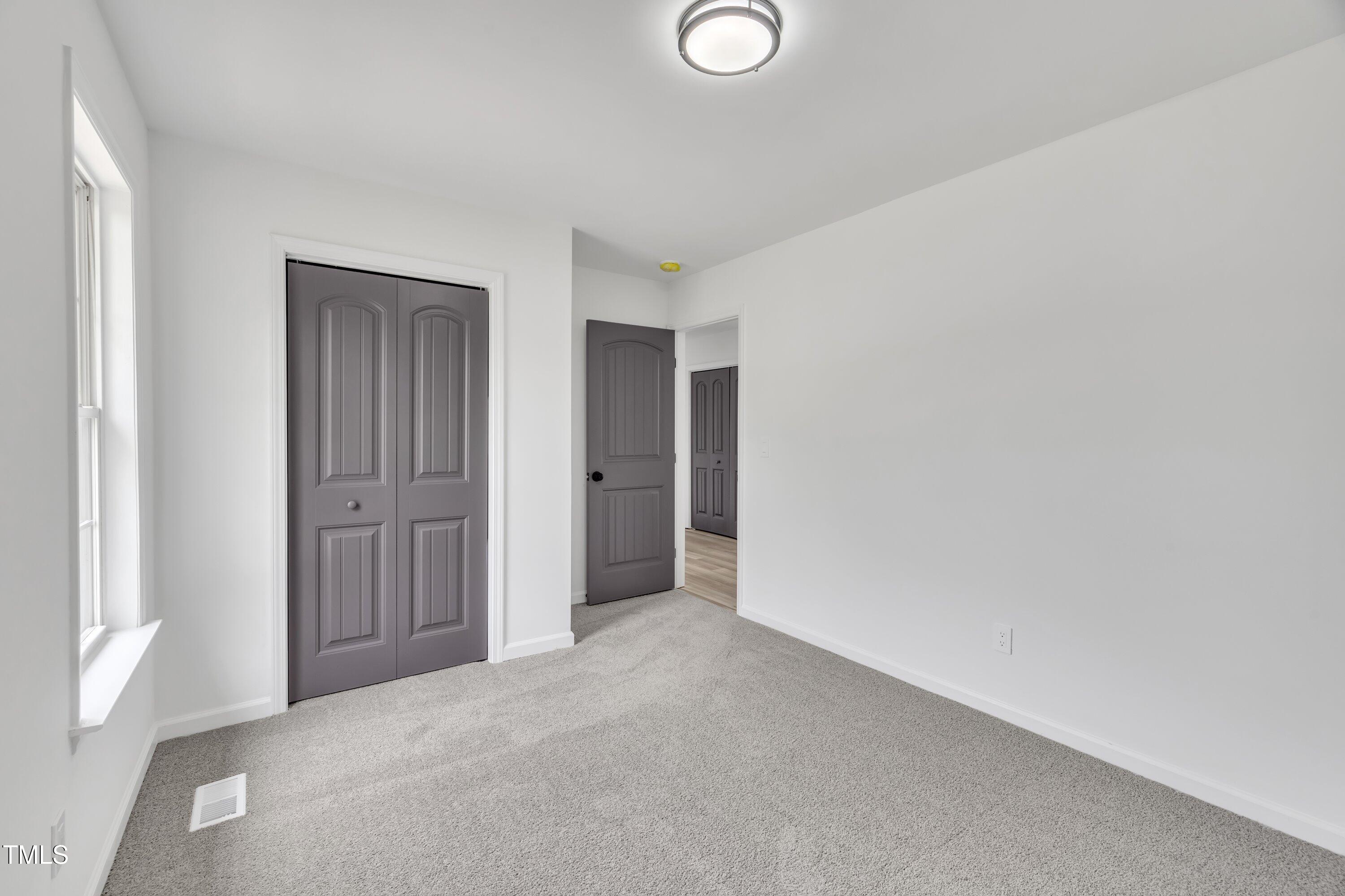 112 Edmondson Drive Willow Spring, NC 27592 - Photo 18 of 32 a view of an empty room and window