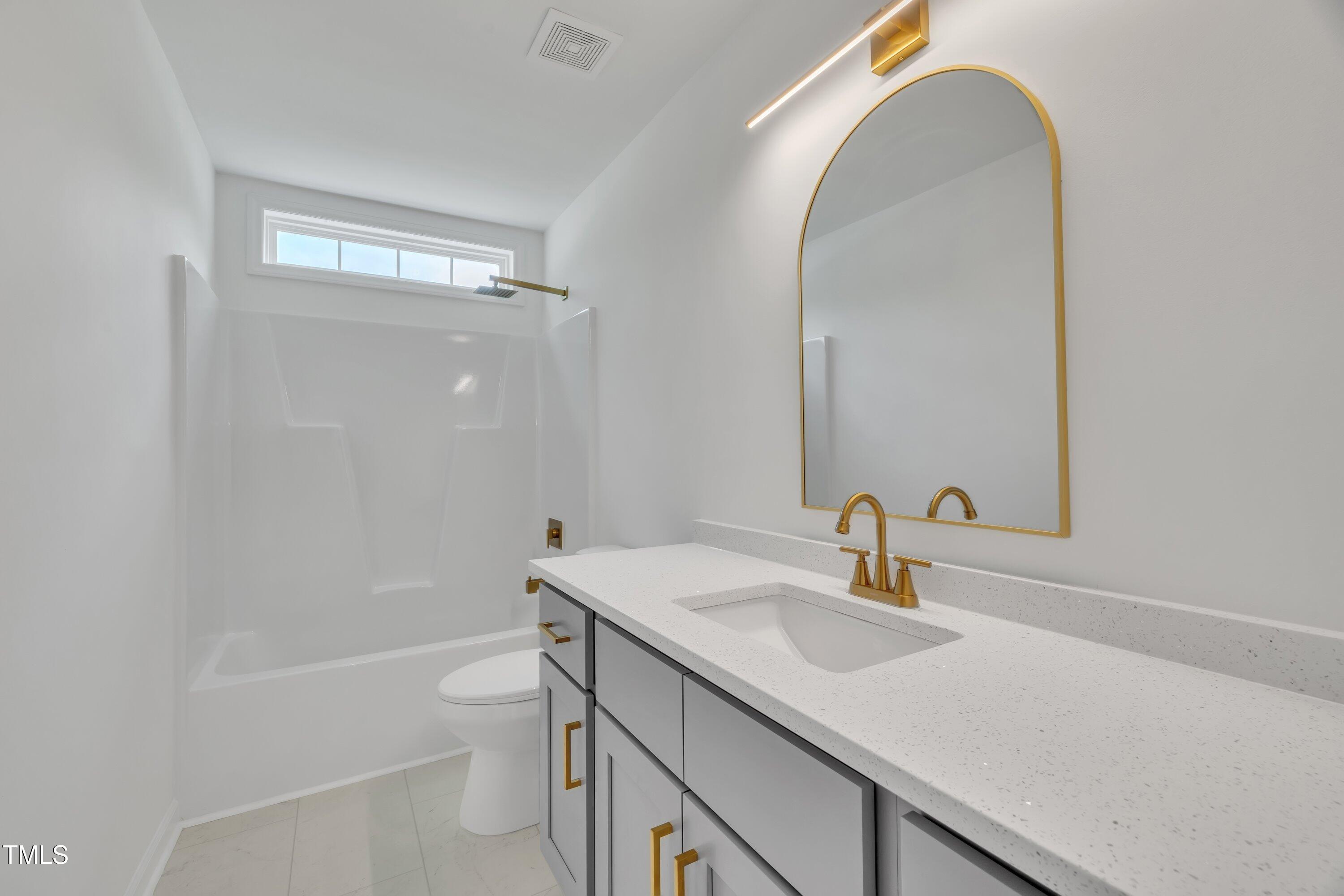 112 Edmondson Drive Willow Spring, NC 27592 - Photo 23 of 32 a bathroom with a sink a toilet and shower