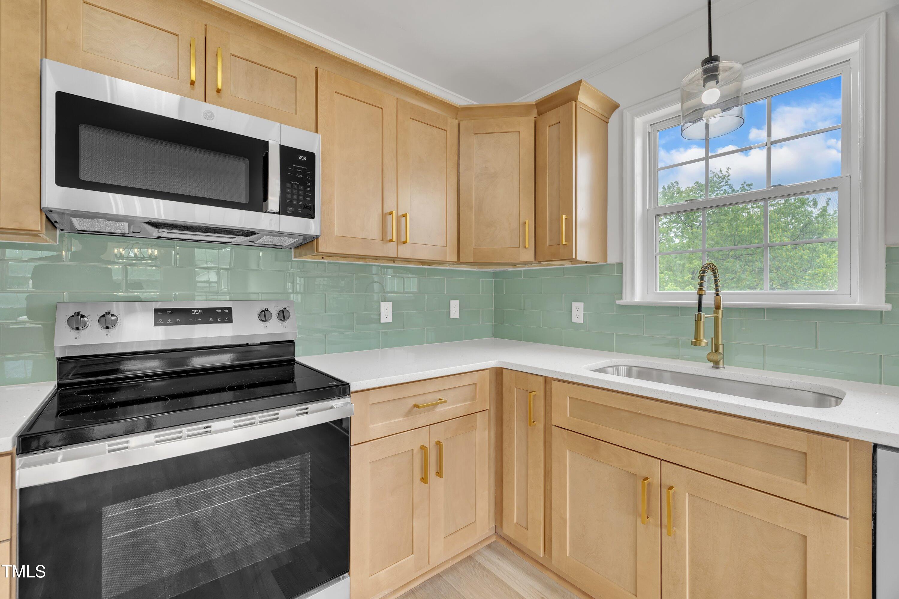 112 Edmondson Drive Willow Spring, NC 27592 - Photo 2 of 32 a kitchen with a sink stove and microwave