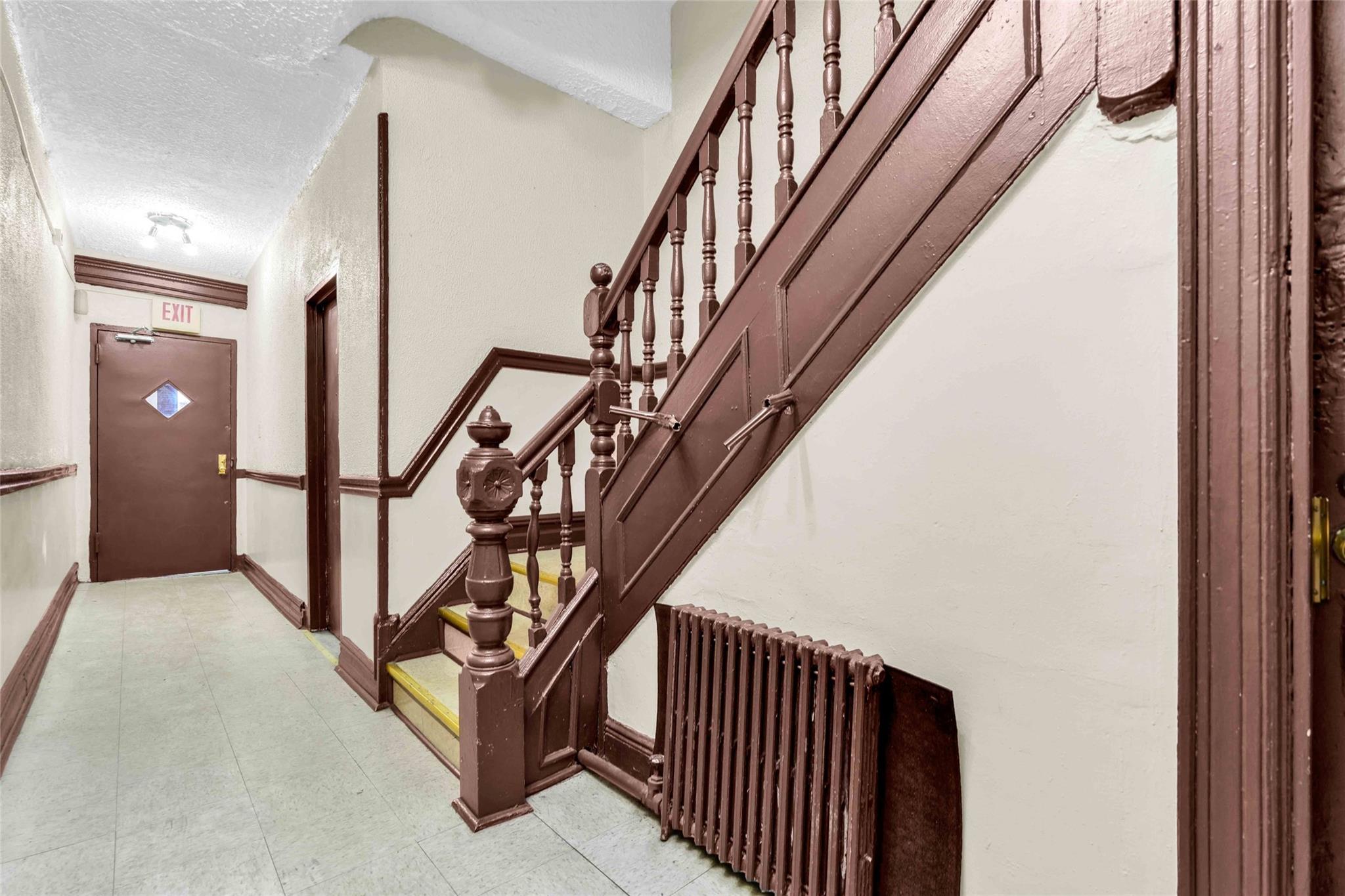 2146 Cortelyou Road, Unit 1R Brooklyn, NY 11226 - Photo 8 of 12 Stairway with baseboards, radiator heating unit, and a textured ceiling