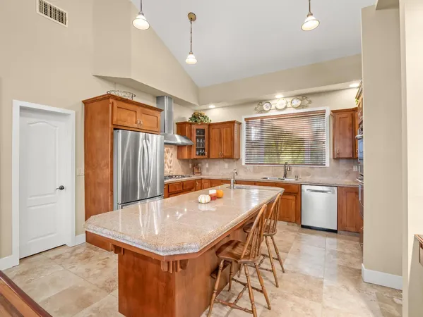 a kitchen with granite countertop a sink stove and cabinets