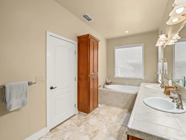 a spacious bathroom with a shower and a sink