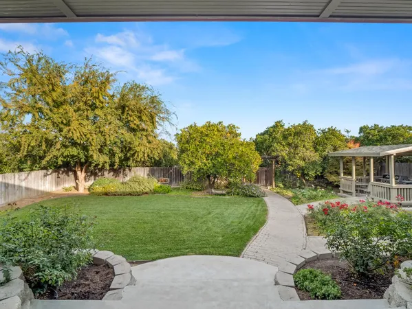 a view of a garden with a building in the background