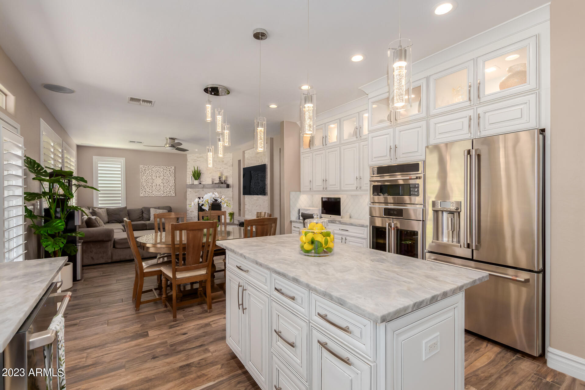 3416 West Montello Road Phoenix, AZ 85086 - Photo 22 of 71 a kitchen with stainless steel appliances granite countertop a refrigerator a stove and a dining table with wooden floor