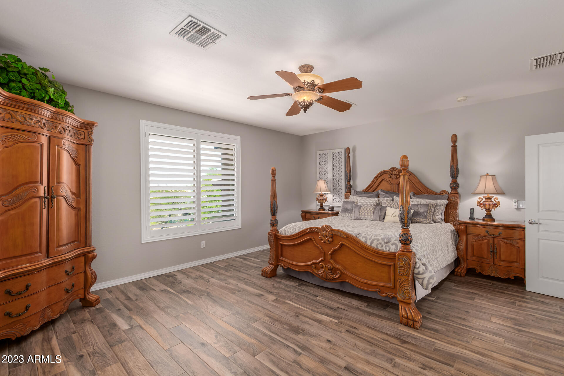 3416 West Montello Road Phoenix, AZ 85086 - Photo 34 of 71 a bedroom with a bed a chandelier and a dresser