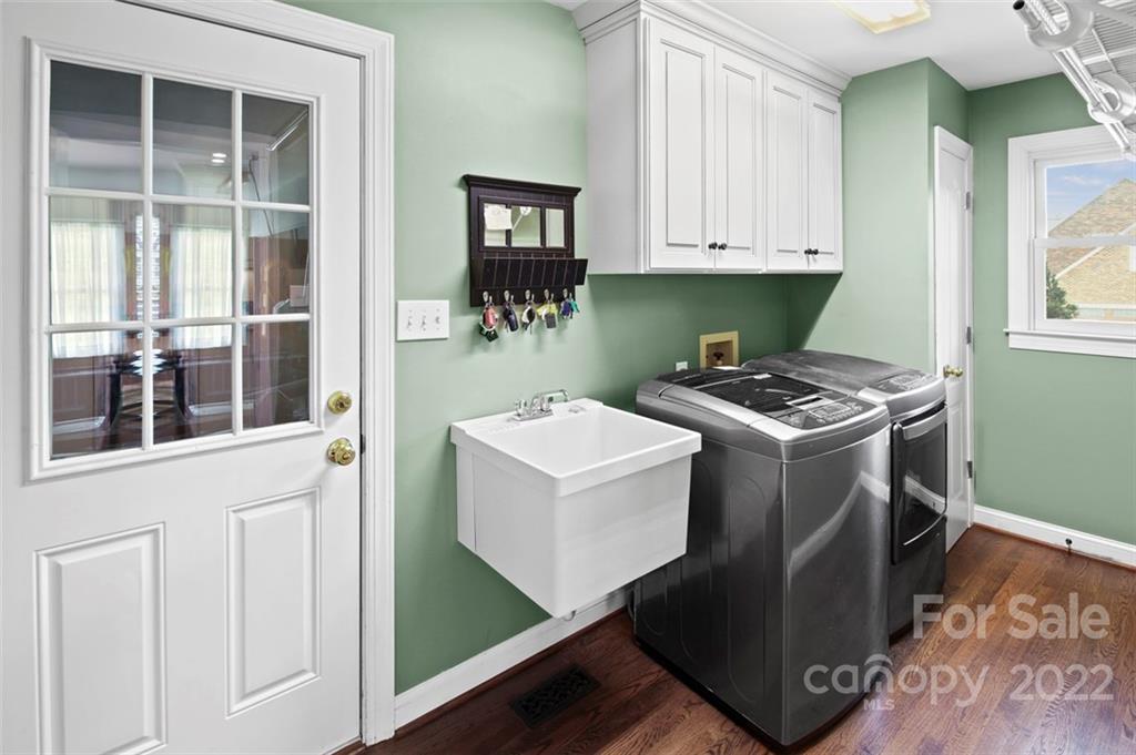 8438 Fairfield Forest Road Denver, NC 28037 - Photo 14 of 34 a utility room with cabinets dryer and washer