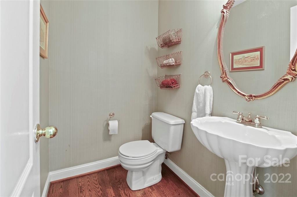 8438 Fairfield Forest Road Denver, NC 28037 - Photo 15 of 34 a bathroom with a toilet sink and mirror