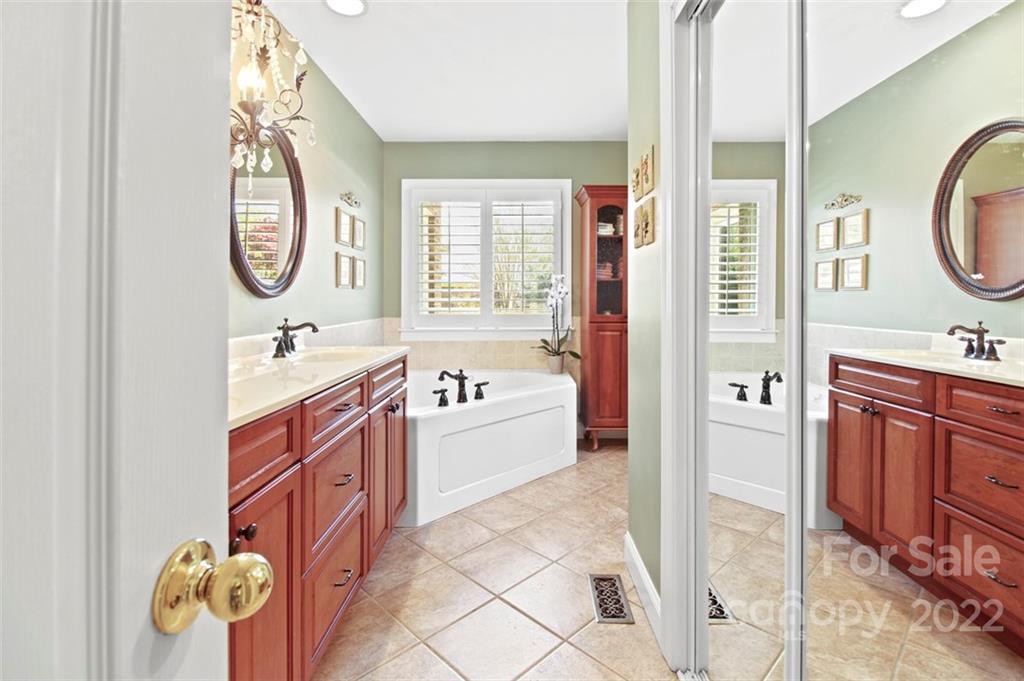 8438 Fairfield Forest Road Denver, NC 28037 - Photo 19 of 34 a spacious bathroom with a mirror a sink and a mirror