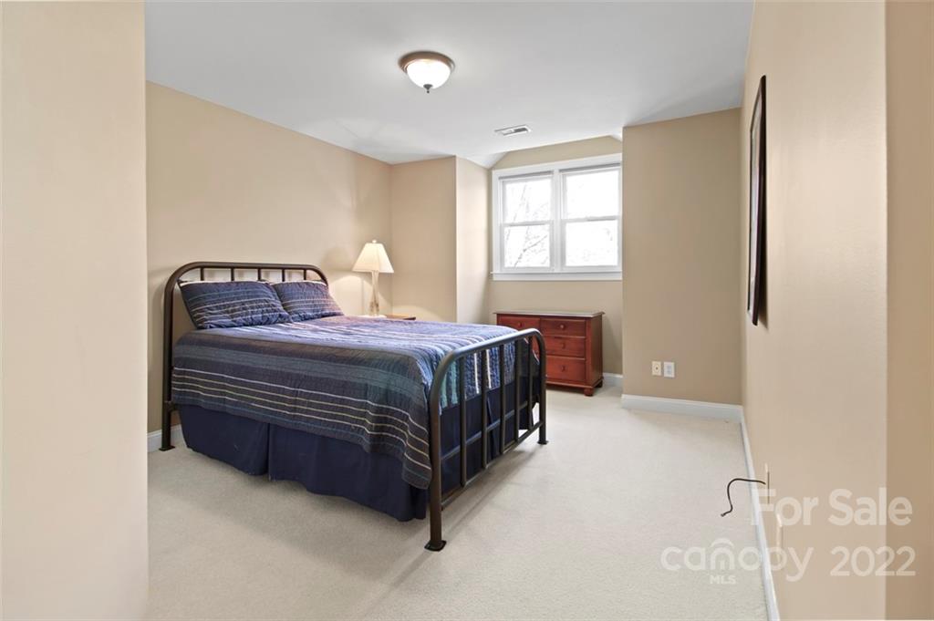 8438 Fairfield Forest Road Denver, NC 28037 - Photo 23 of 34 a bedroom with a bed lamp and a window