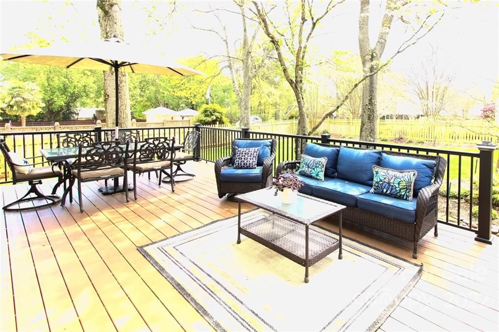 8438 Fairfield Forest Road Denver, NC 28037 - Photo 4 of 34 a view of a roof deck with couches and potted plants