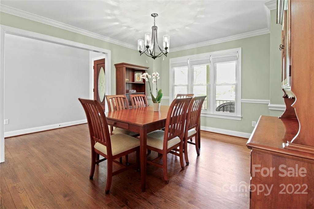8438 Fairfield Forest Road Denver, NC 28037 - Photo 8 of 34 a view of a dining room with furniture window and wooden floor