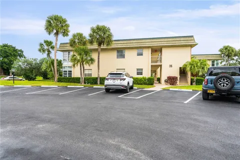 a car parked in front of a house with a yard