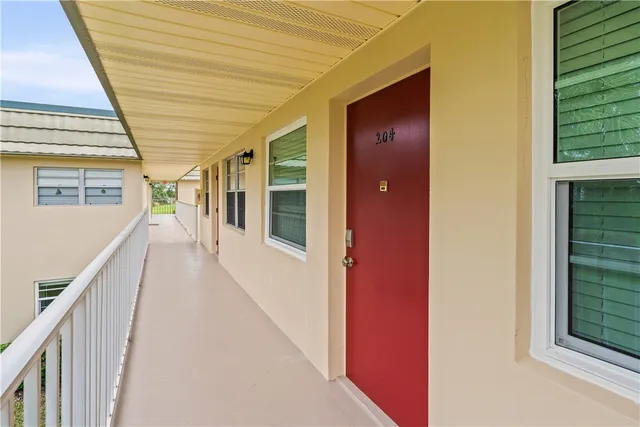 an aerial view of a houses with a swimming pool