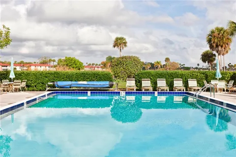 a swimming pool with some trees in the background